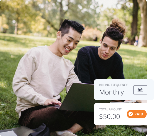 Two men sit on a grassy field using a computer to check their billing history. The additional caption on the image shows a monthly billing frequency, and $50 charged per month. The bill is marked as 'paid'.