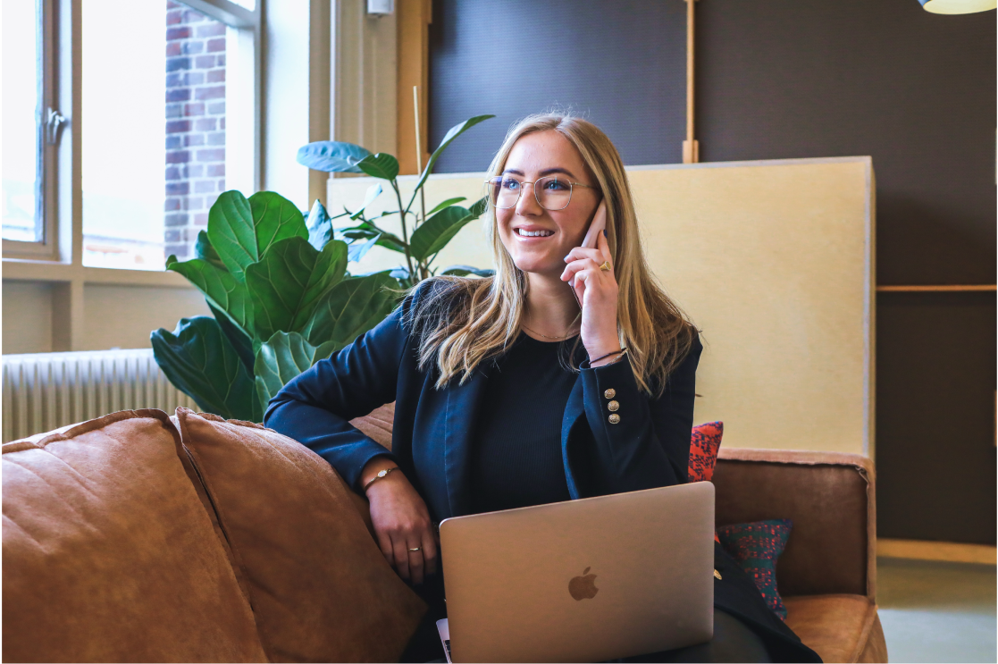 Woman on the phone with her work laptop.