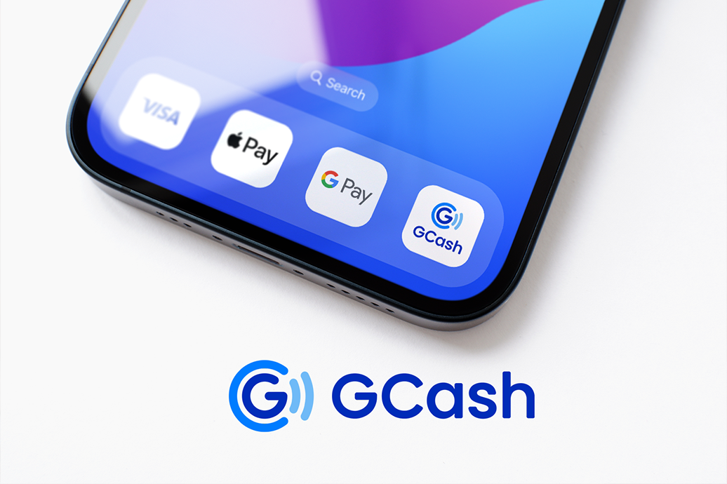 An image of a smartphone displaying the GCash digital wallet app for payments, with options for customer-initiated and merchant-initiated transactions.