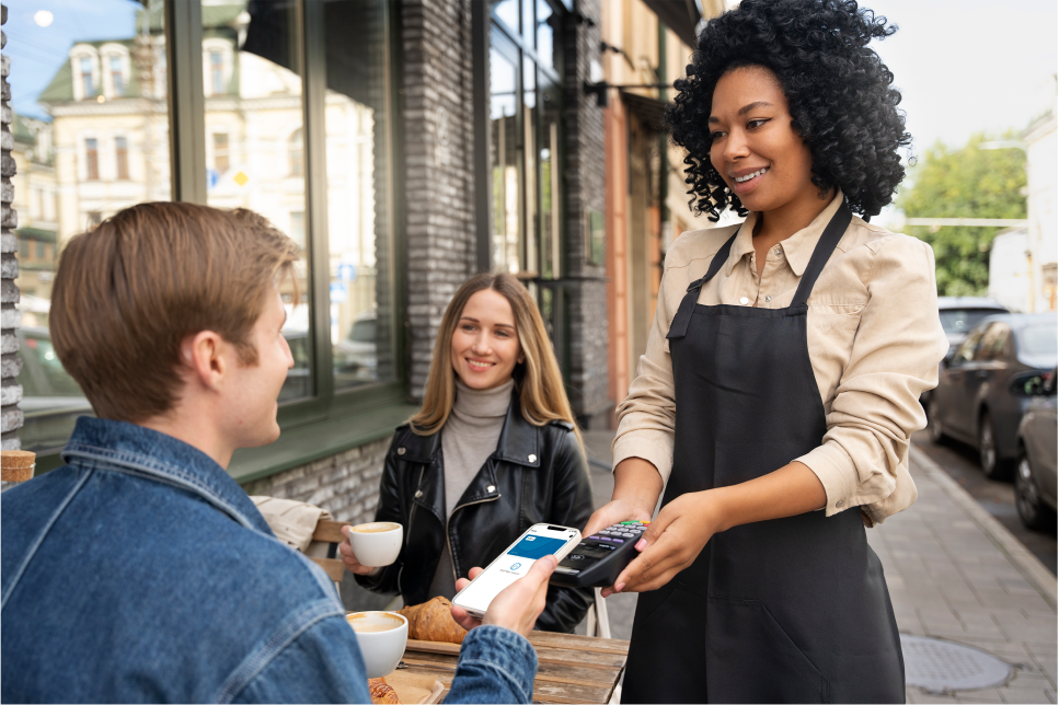 A man paying coffee with his ewallet to the cafe waitress